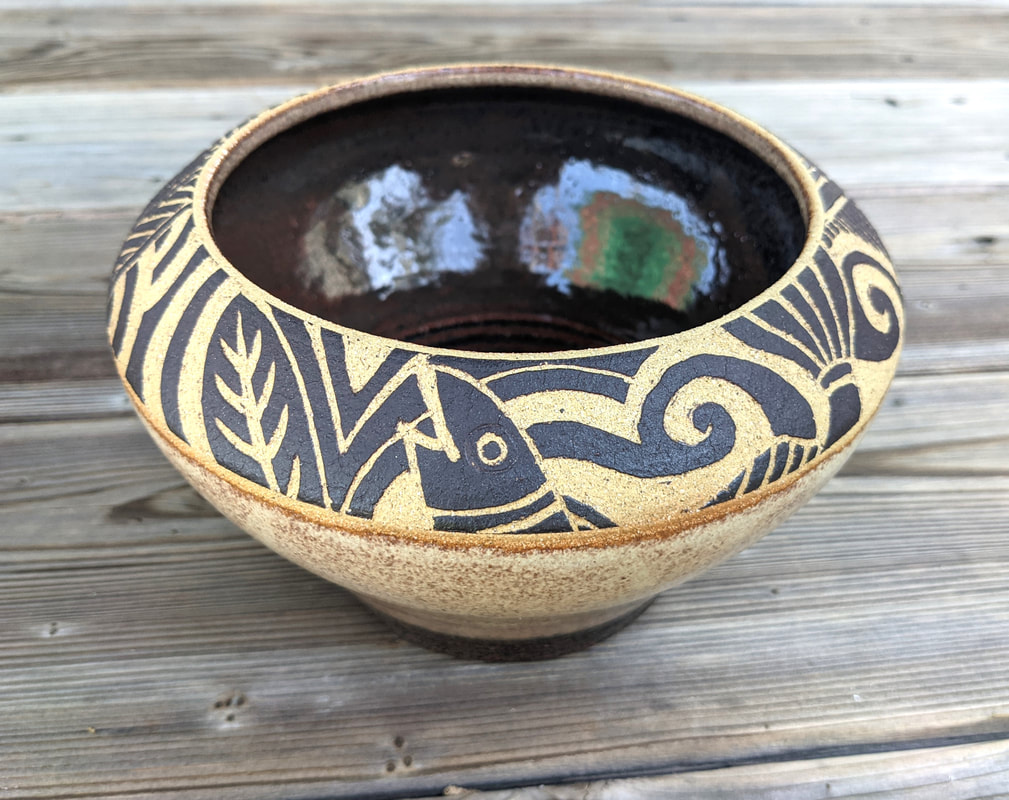 Bowl with black glaze inside and raw clay outside